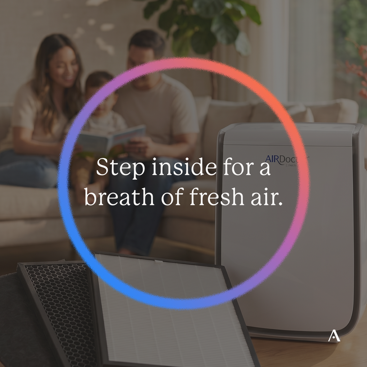 AirDoctor 2000 purifier and filters in front of a family reading on a sofa