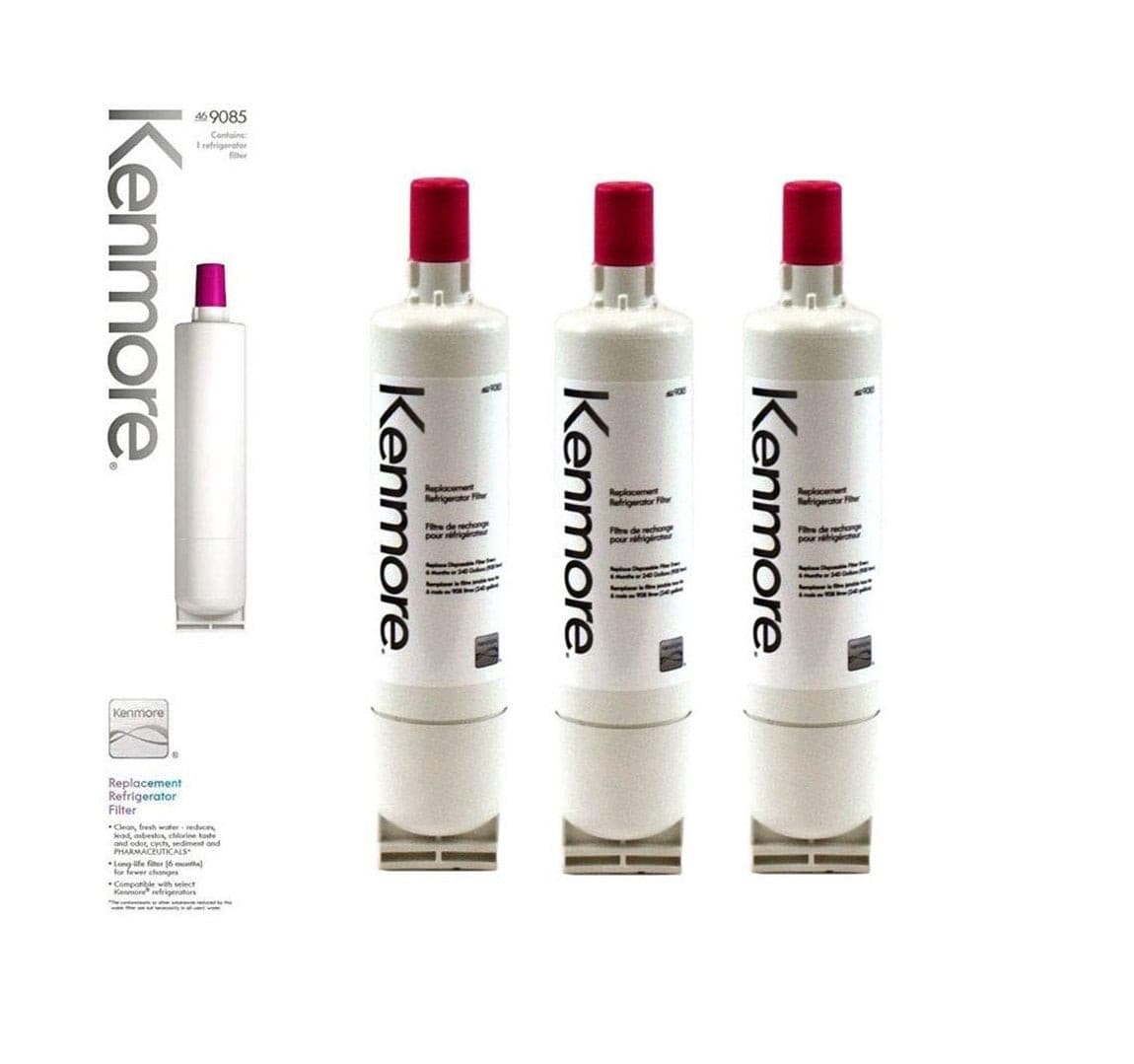 Three Kenmore 9085 refrigerator water filters with pink caps beside retail packaging